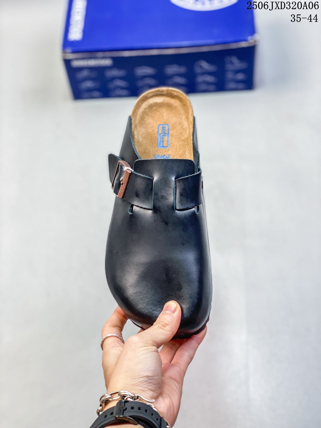 Top view of a black clog showing its contoured footbed and buckle strap; size range 35–44 is printed in the image.
