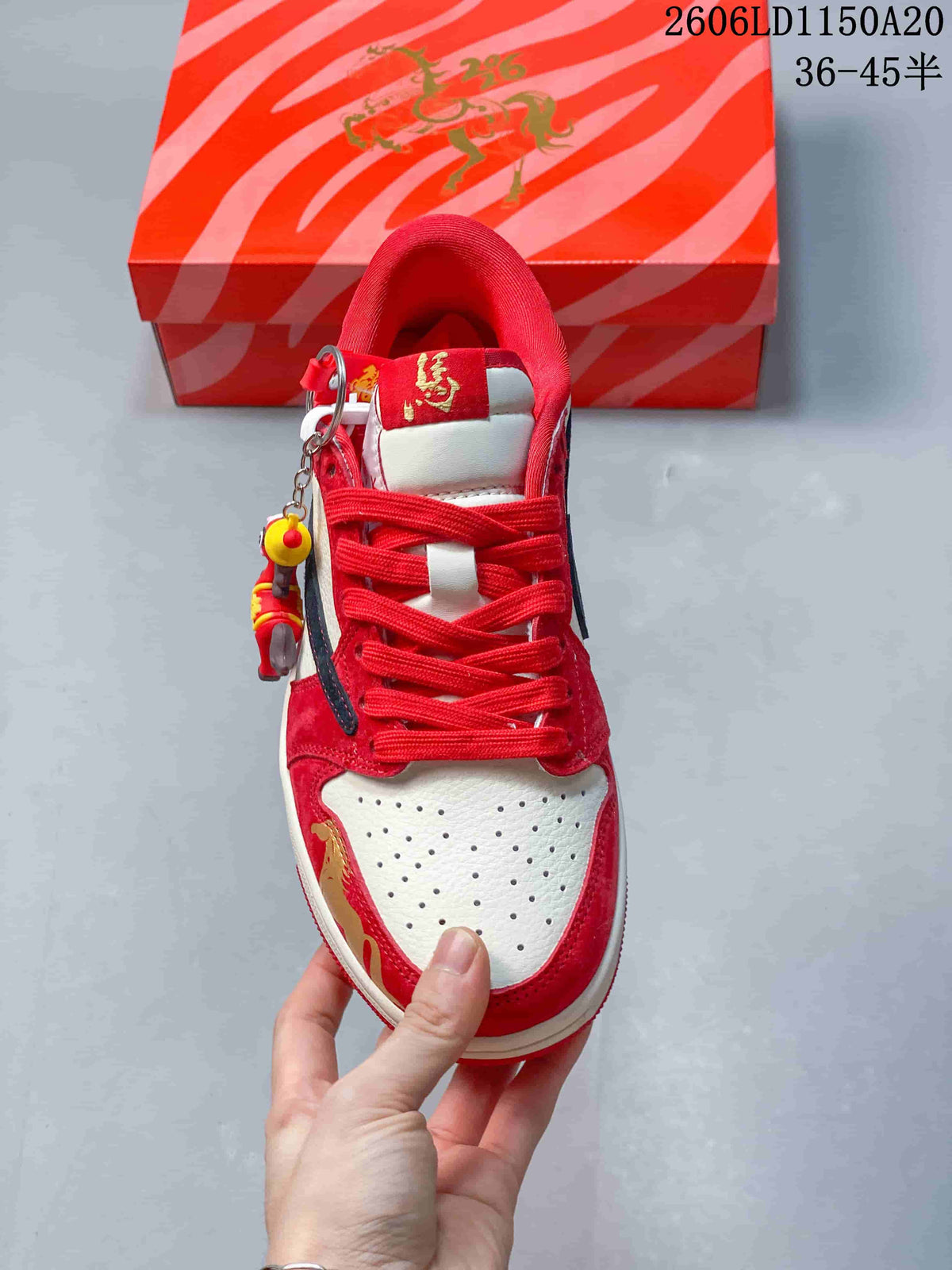 Top view showing perforated toe, red laces, and decorative charm
