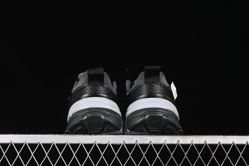 Rear view of both sneakers showing heel details and outsoles