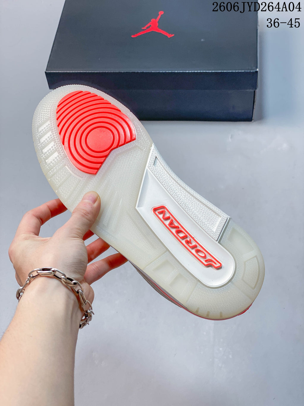 Translucent outsole with a red-orange circular tread section on a Jordan sneaker