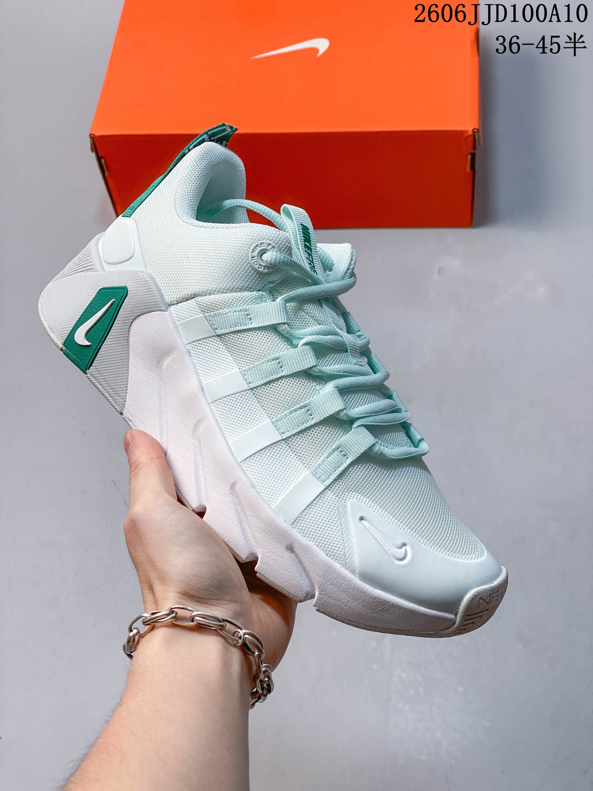 White and pale mint Nike Free Metcon 7 shoe with green heel detail.