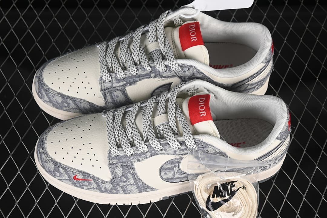 Pair of ivory and gray low-top sneakers with patterned laces and extra light-colored laces