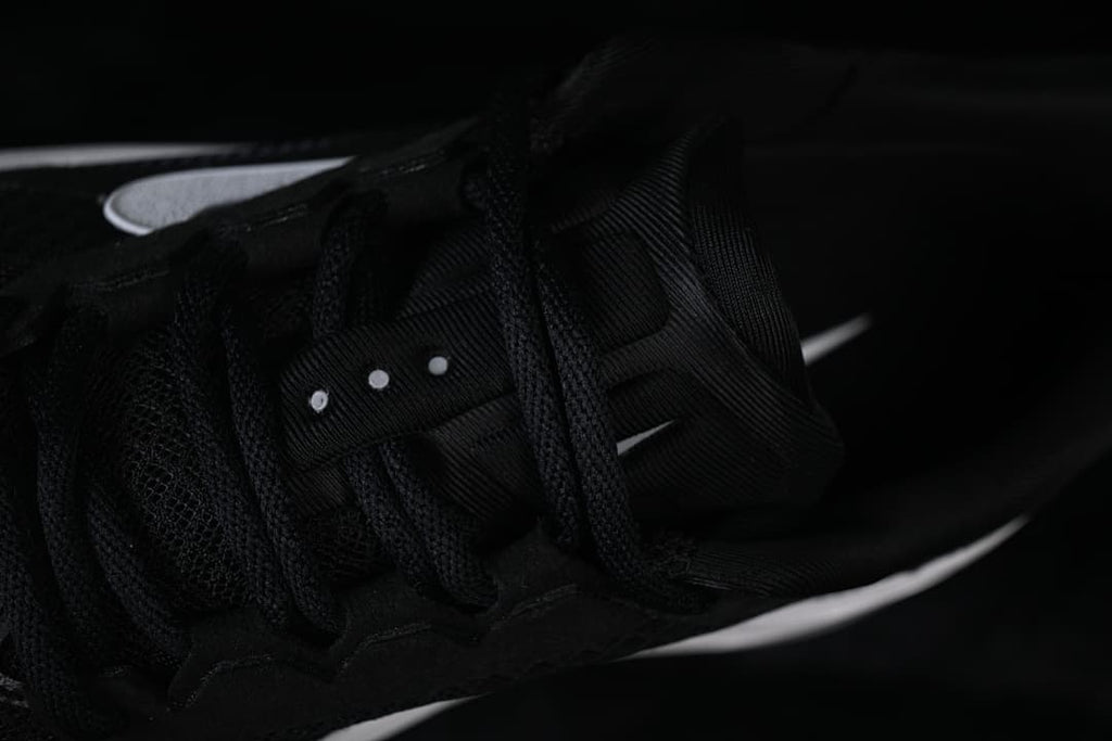 Close-up of the black laces and lace area.