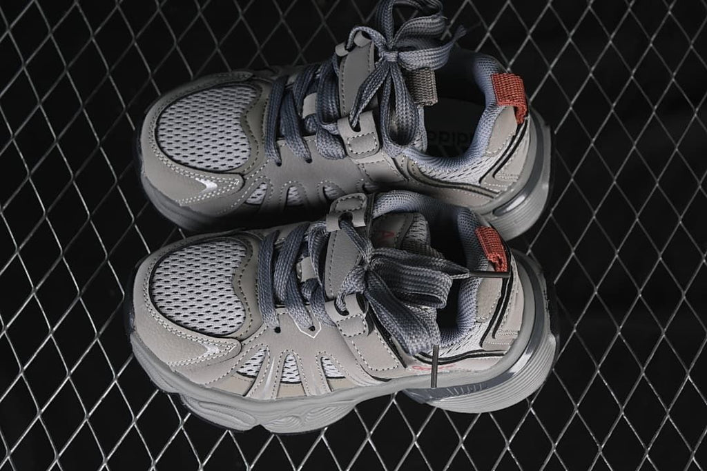 Top-down view of the pair of grey kids’ sneakers.