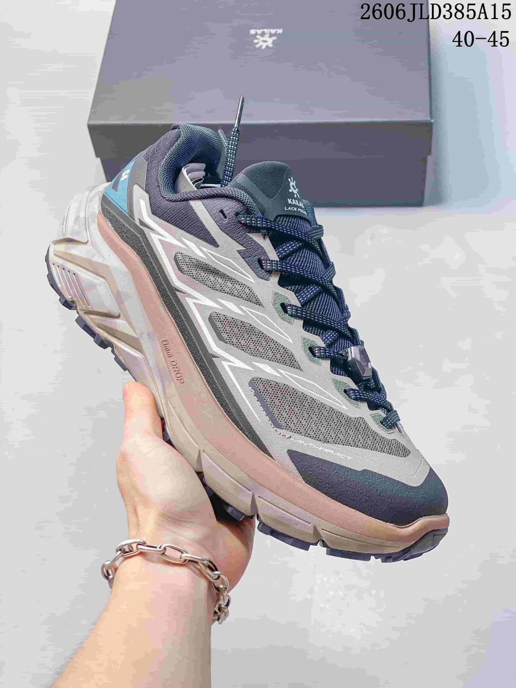Light gray and navy Kailas C4 trail running shoe with a lugged outsole.