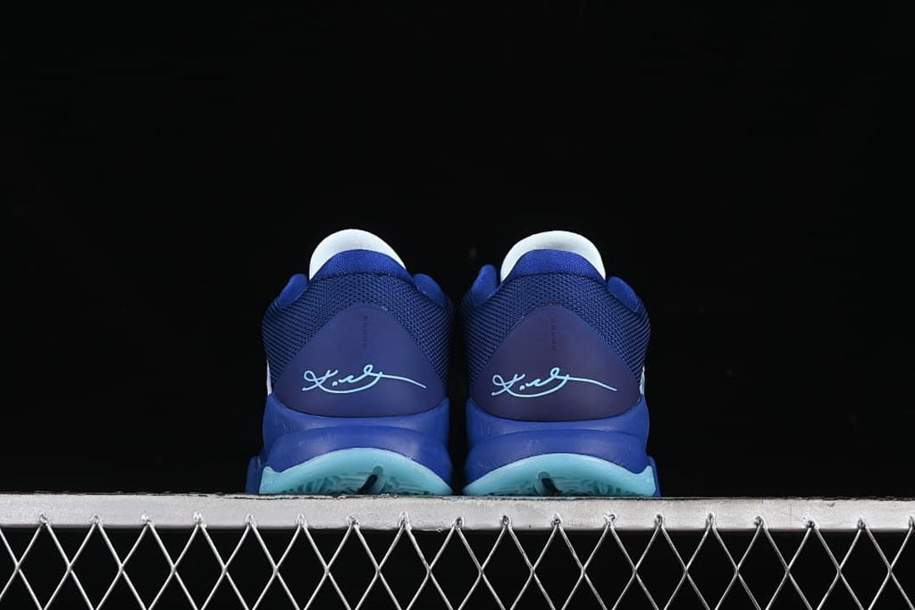 Rear view of the pair showing heel signatures and aqua outsole