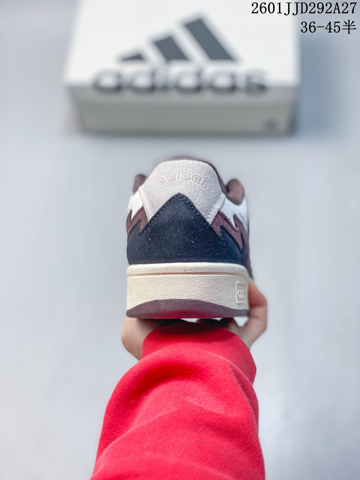 Rear view showing the contrasting heel panels and cream-colored midsole of an Adidas Wcard Adv sneaker.