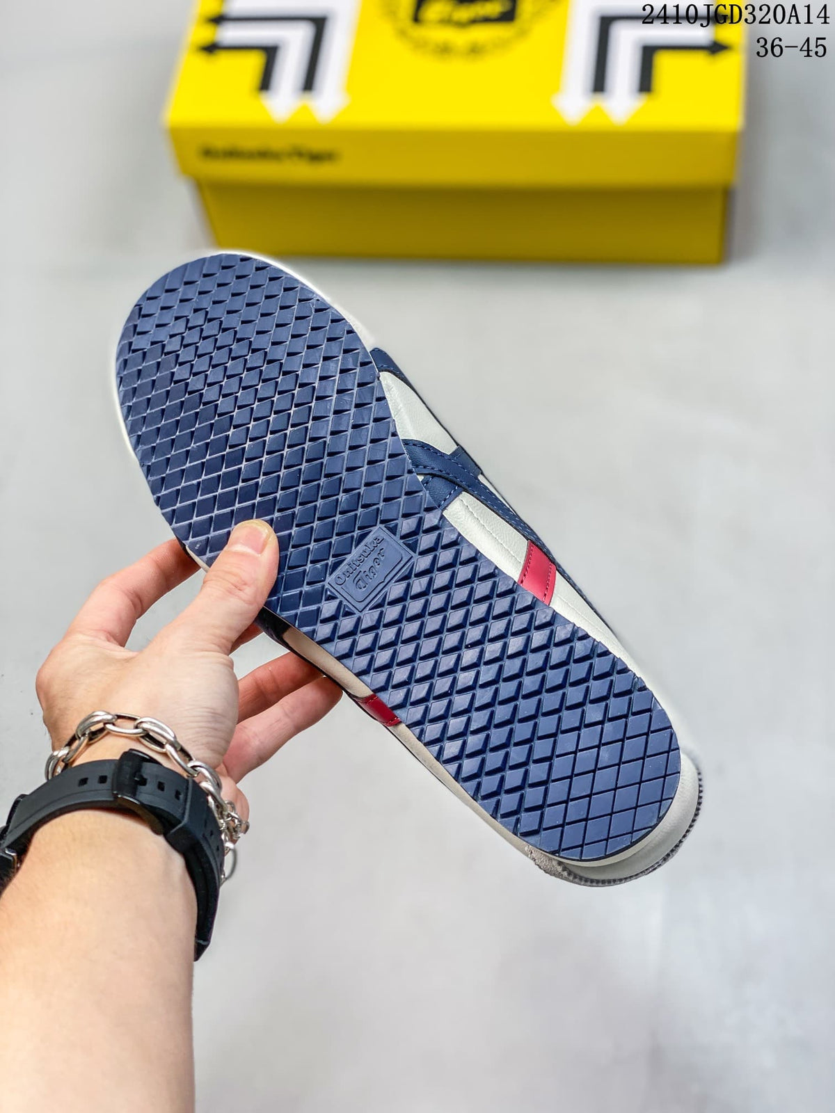 Close-up of the navy patterned outsole on a white and blue sneaker