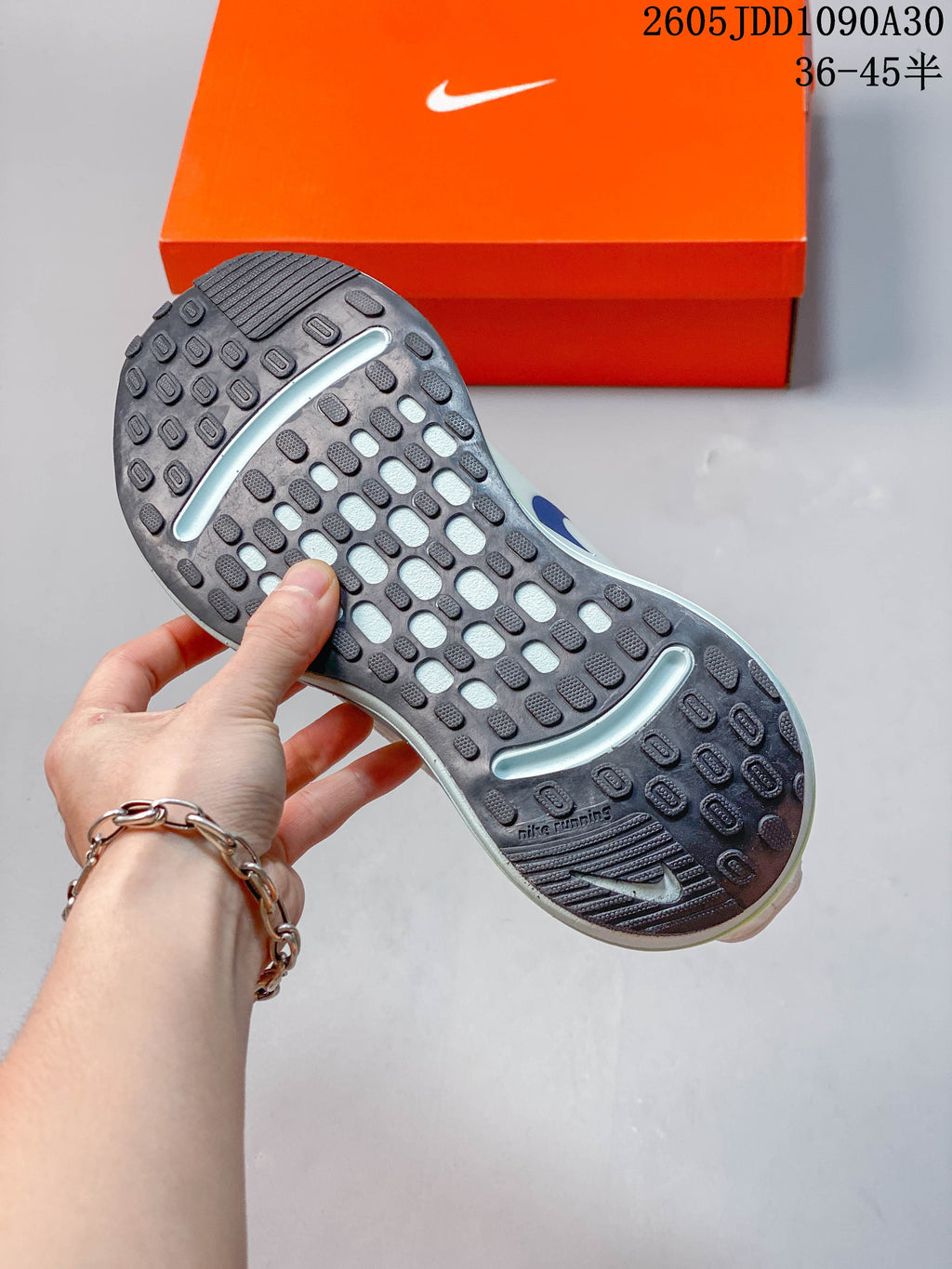 Close-up of the patterned outsole on a Nike Journey Run shoe.