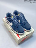 Pair of navy Nike SB Dunk Low sneakers with cream Swoosh panels and gold accents on a Nike box