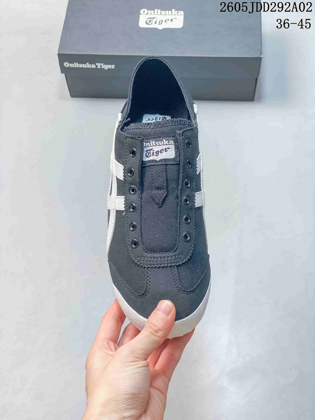 Top view showing the lace-free front and eyelet details of a charcoal sneaker