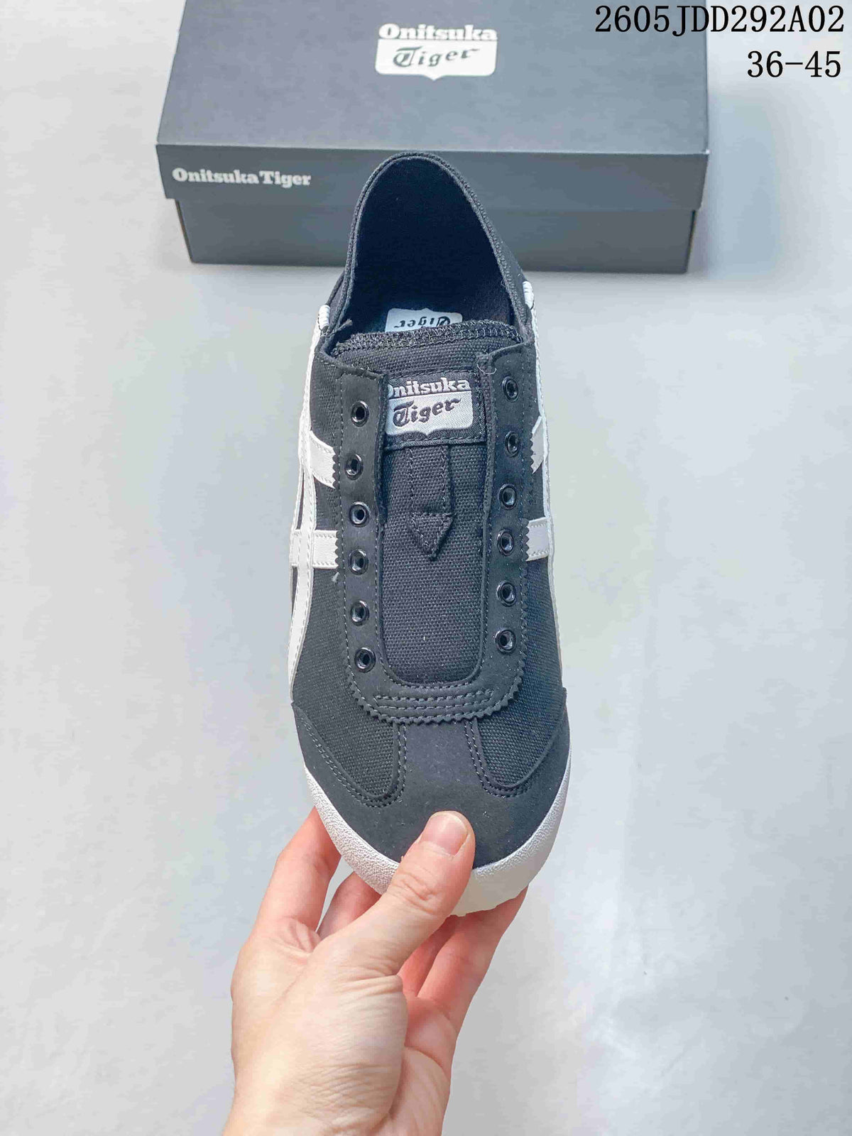 Top view showing the lace-free front and eyelet details of a charcoal sneaker