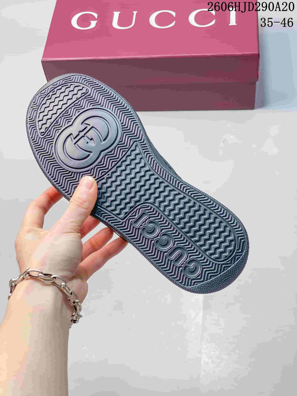 Underside of the sneaker showing a textured tread and embossed branding