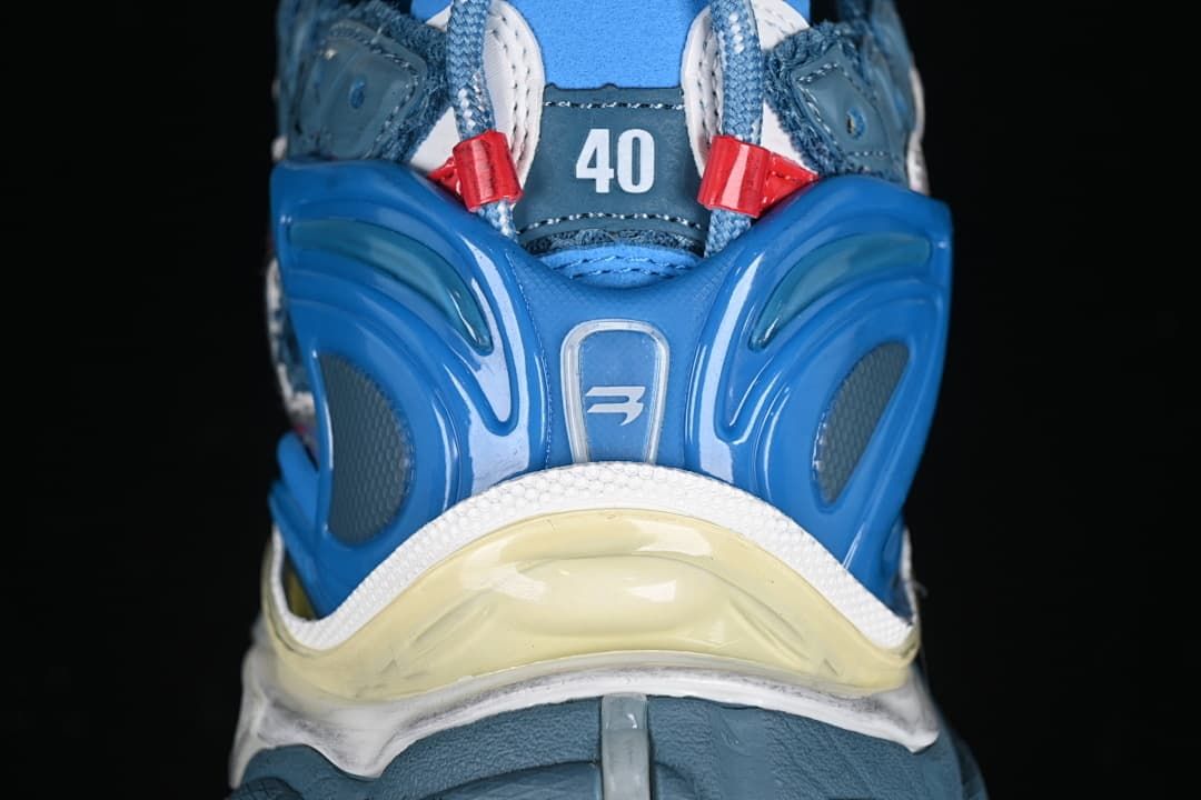 Rear view highlighting the blue heel structure and layered sole
