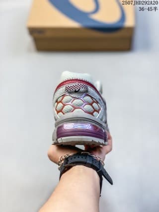 Rear view of the sneaker showing the heel counter, burgundy accents and textured heel details.
