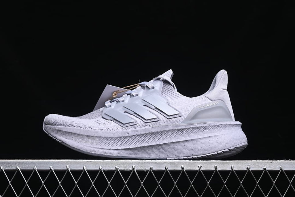Side view of a light grey Adidas Ultraboost 5 running shoe