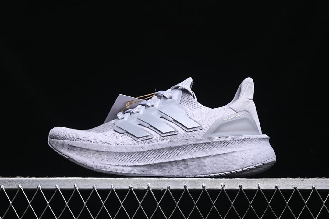 Side view of a light grey Adidas Ultraboost 5 running shoe