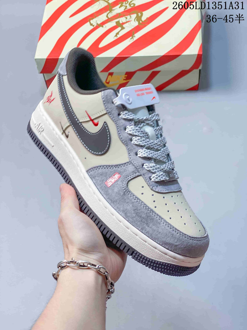 Angled view of the Nike Air Force 1 Low with horse-themed accents and striped box
