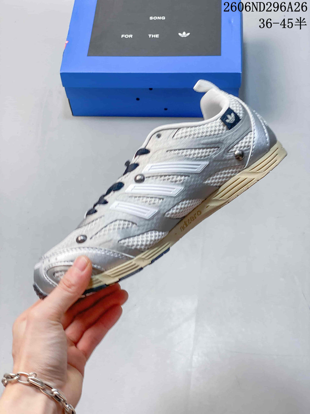 Side profile of the silver and white low-top sneaker