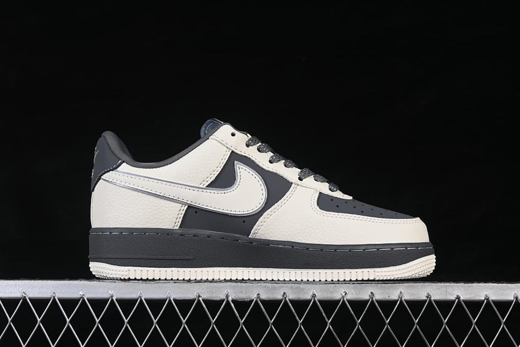 Side view of an off-white and dark gray low-top sneaker