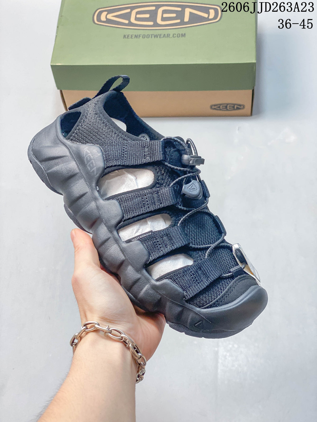 Angled view of the dark navy KEEN sandal and protective toe bumper