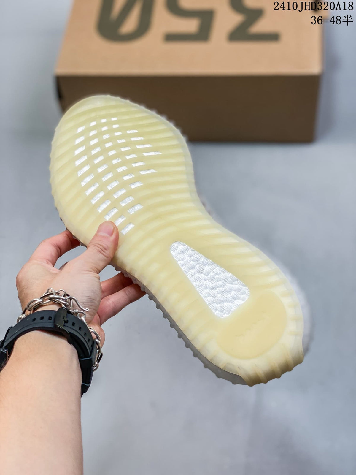 Underside of a Yeezy-style sneaker showing a ribbed, translucent-looking sole