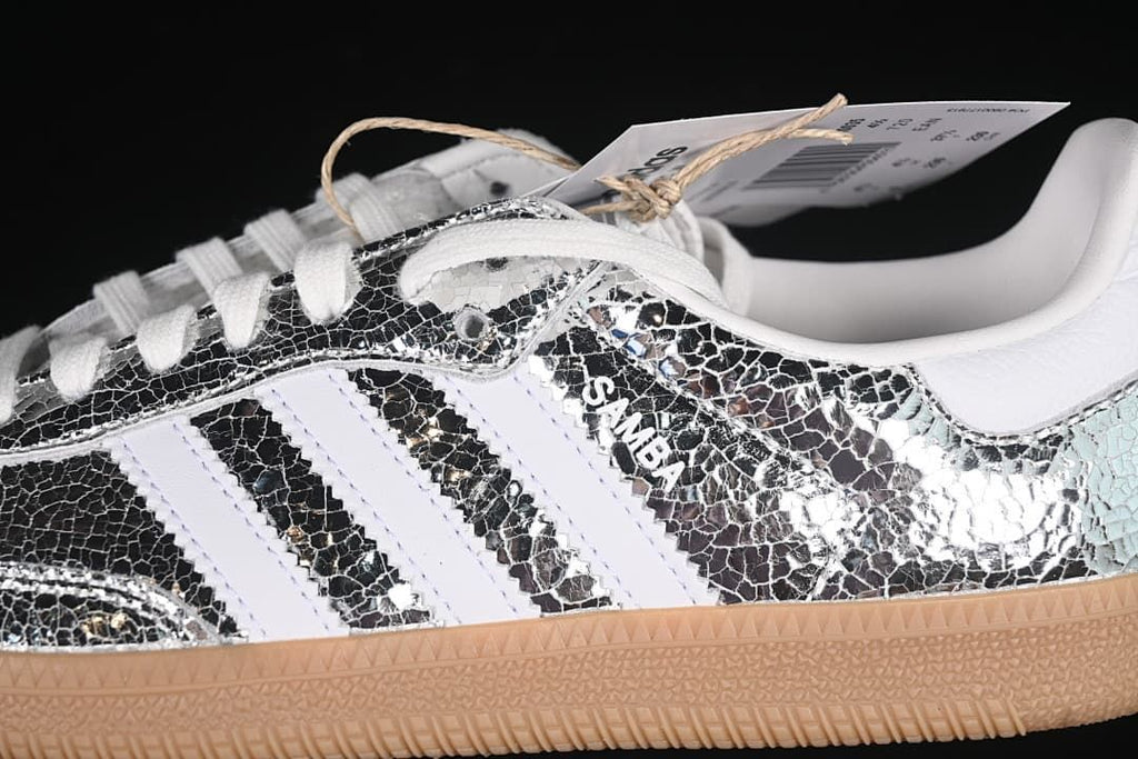 Close-up of the silver patterned side panel, white stripes, laces, and Samba lettering