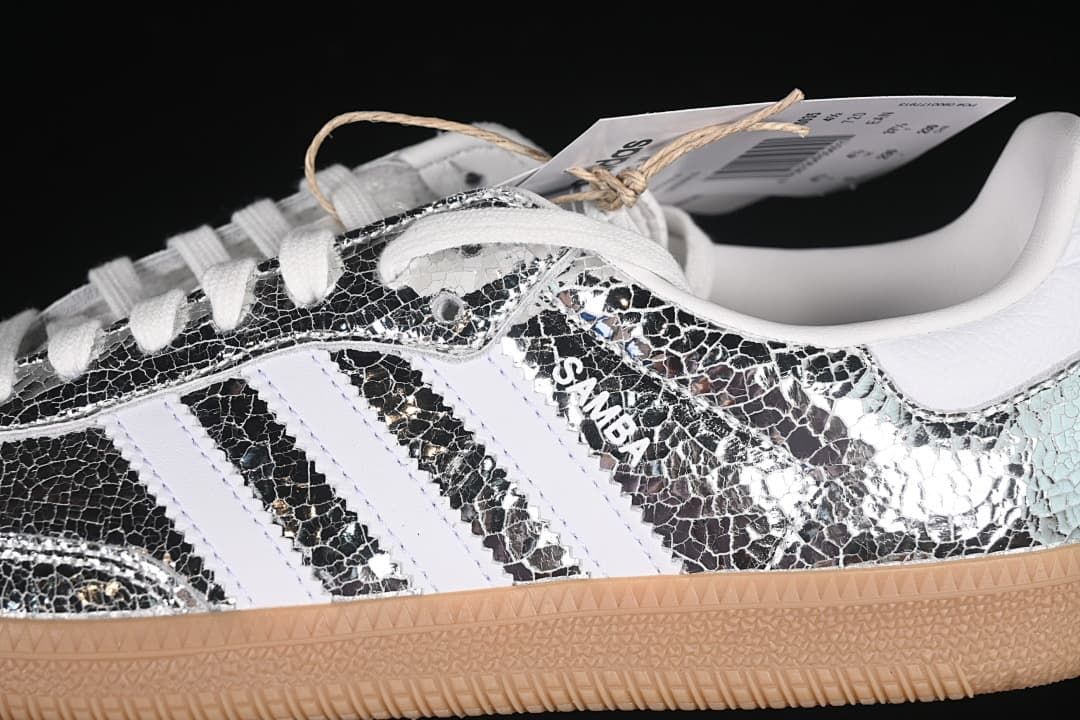 Close-up of the silver patterned side panel, white stripes, laces, and Samba lettering