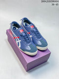 Pair of blue Onitsuka Tiger Mexico 66 Deluxe sneakers on a purple box