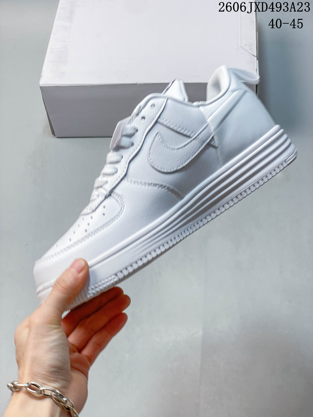 Side view of the white low-top sneaker showing the Swoosh and zipper detail