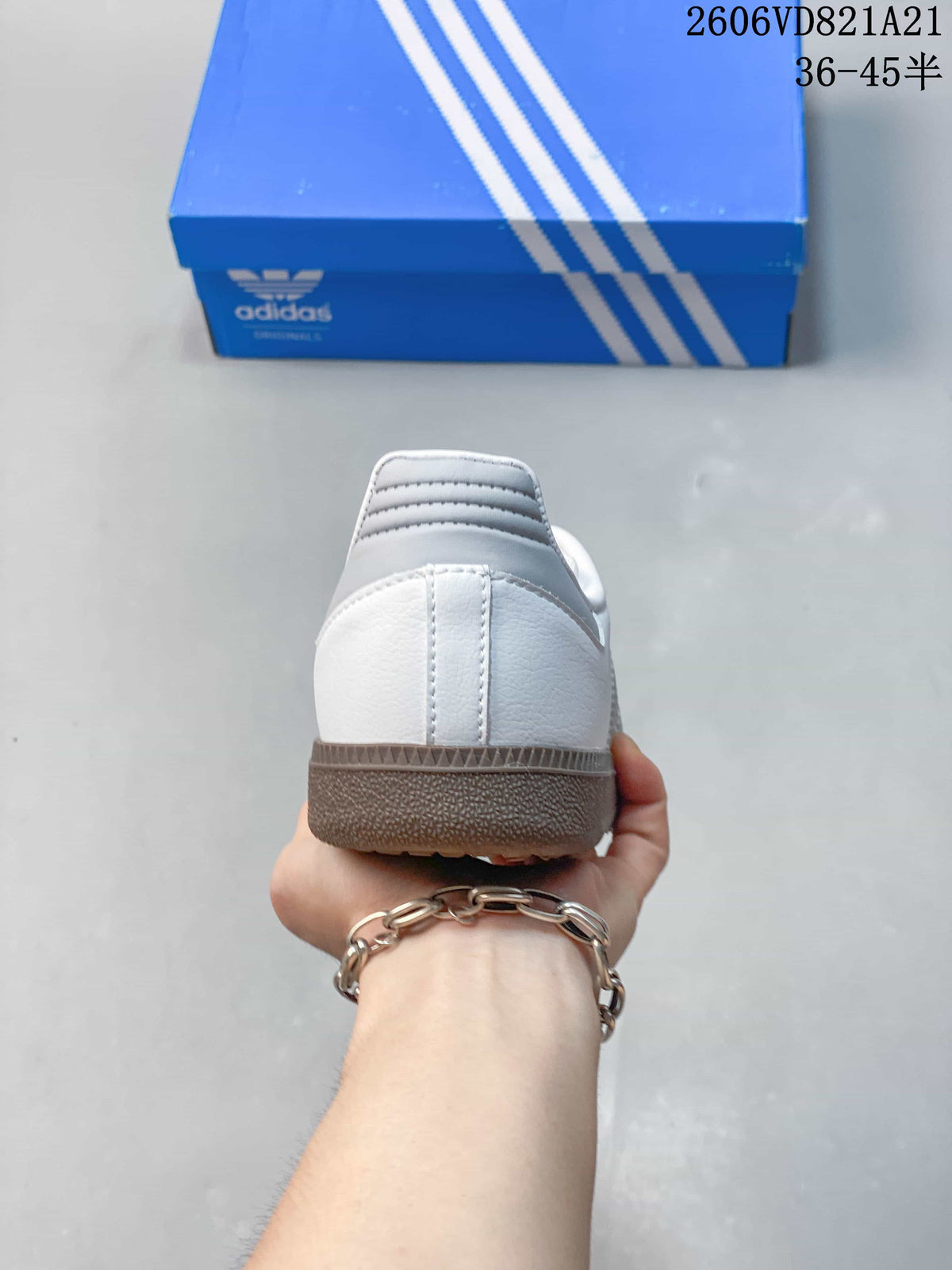 Rear view of a white sneaker with a grey heel detail and gum-colored sole