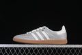 Side view of the silver glitter-effect adidas Samba OG with white stripes and gum-colored outsole.