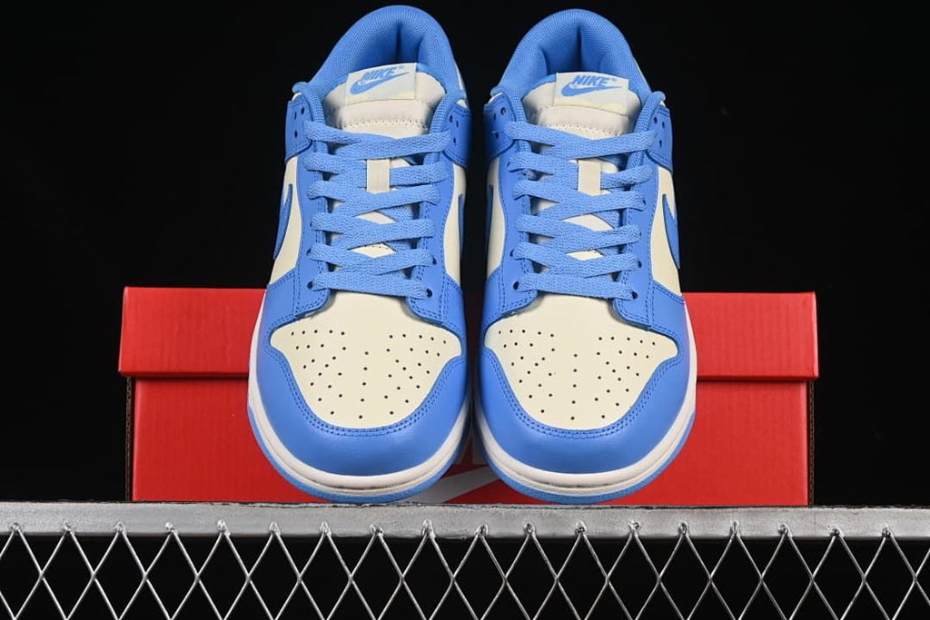 Front view of the pair showing perforated cream toe panels and blue laces
