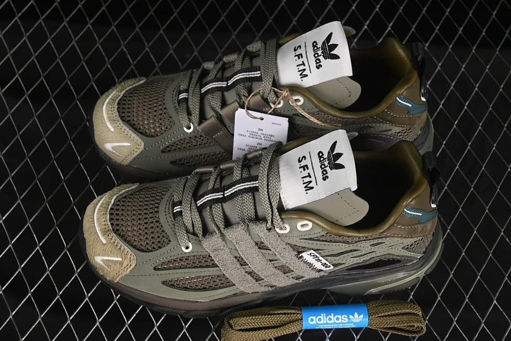 Pair of olive-toned sneakers shown from above with spare laces.