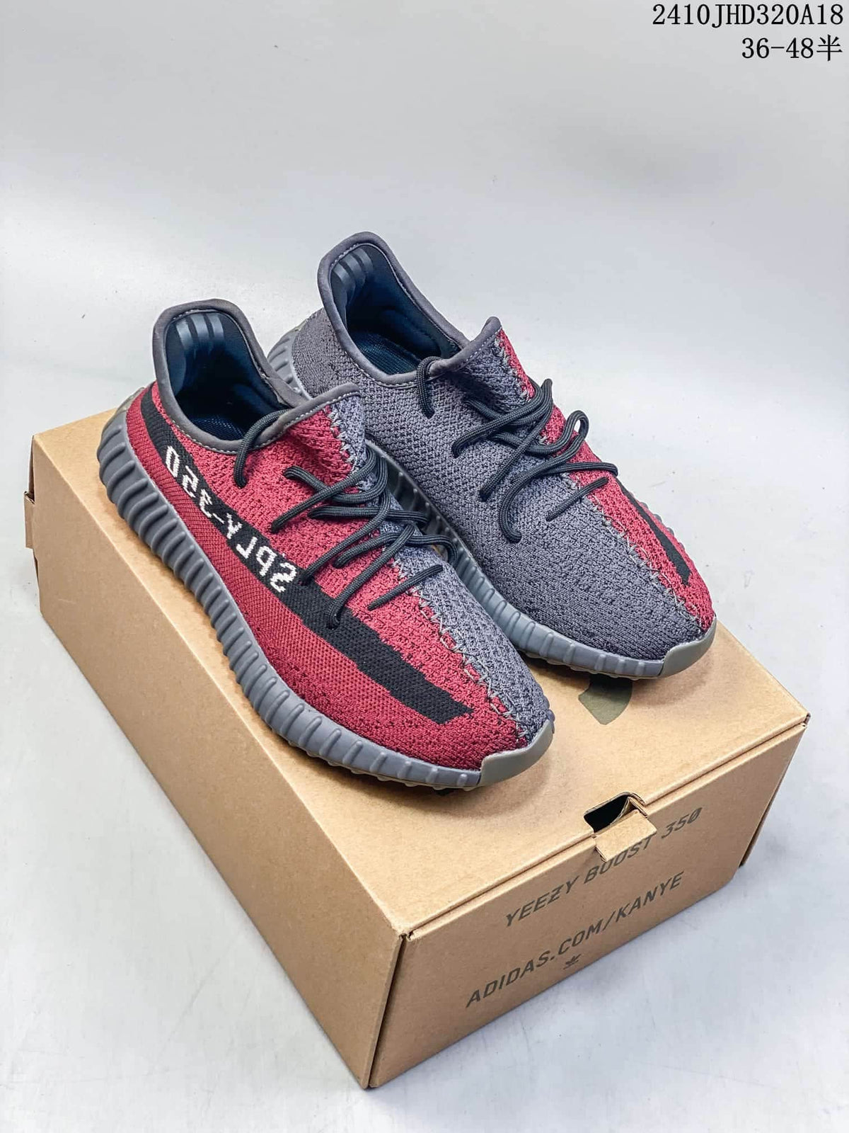 Gray and red Adidas Yeezy Boost 350 V2 sneakers shown from above on a box