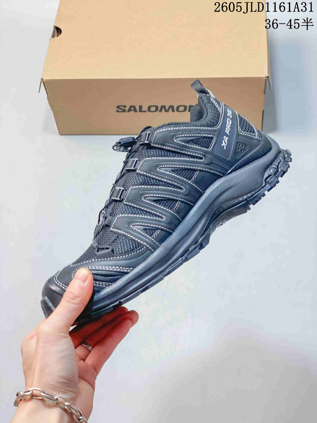 Side profile of a dark gray Salomon XA Pro 3D sneaker with cord lacing and mesh panels.