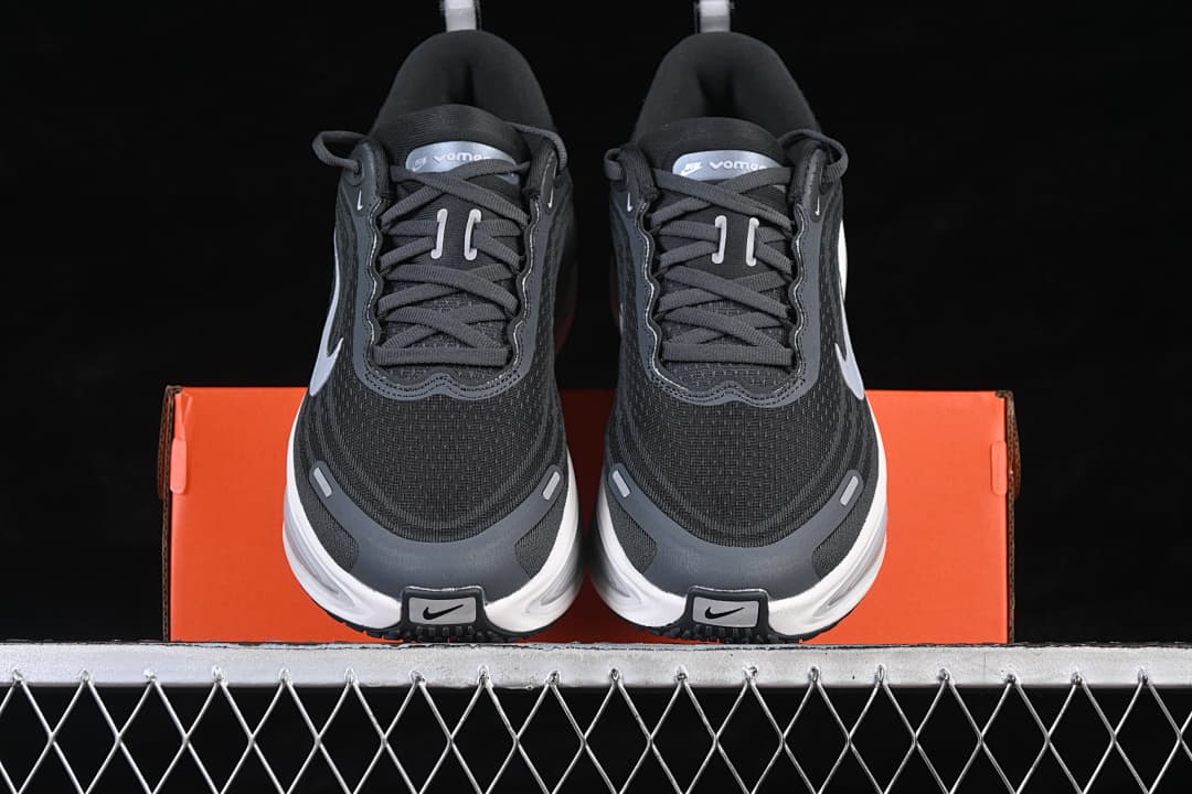 Front view of the pair showing dark uppers, light Swoosh details, and thick white midsoles.