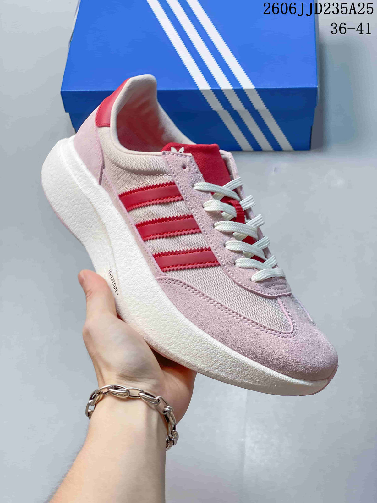 Side view of a pink Adidas Adizero SL 72 Pro sneaker with red stripes