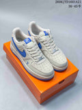 White and blue low-top sneakers shown on an orange box