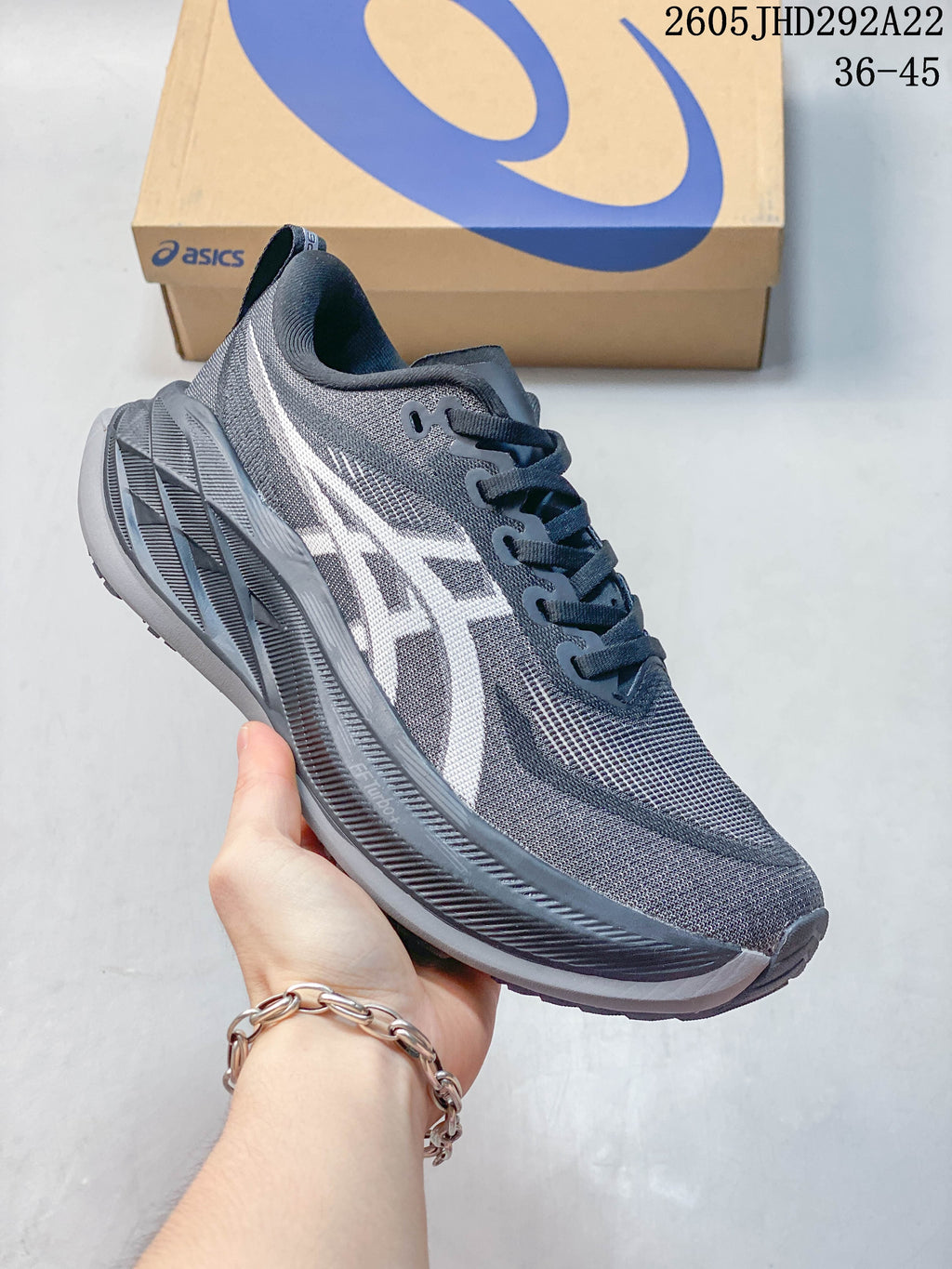 Charcoal gray ASICS Superblast 2 Paris running shoe with contrasting light logo.
