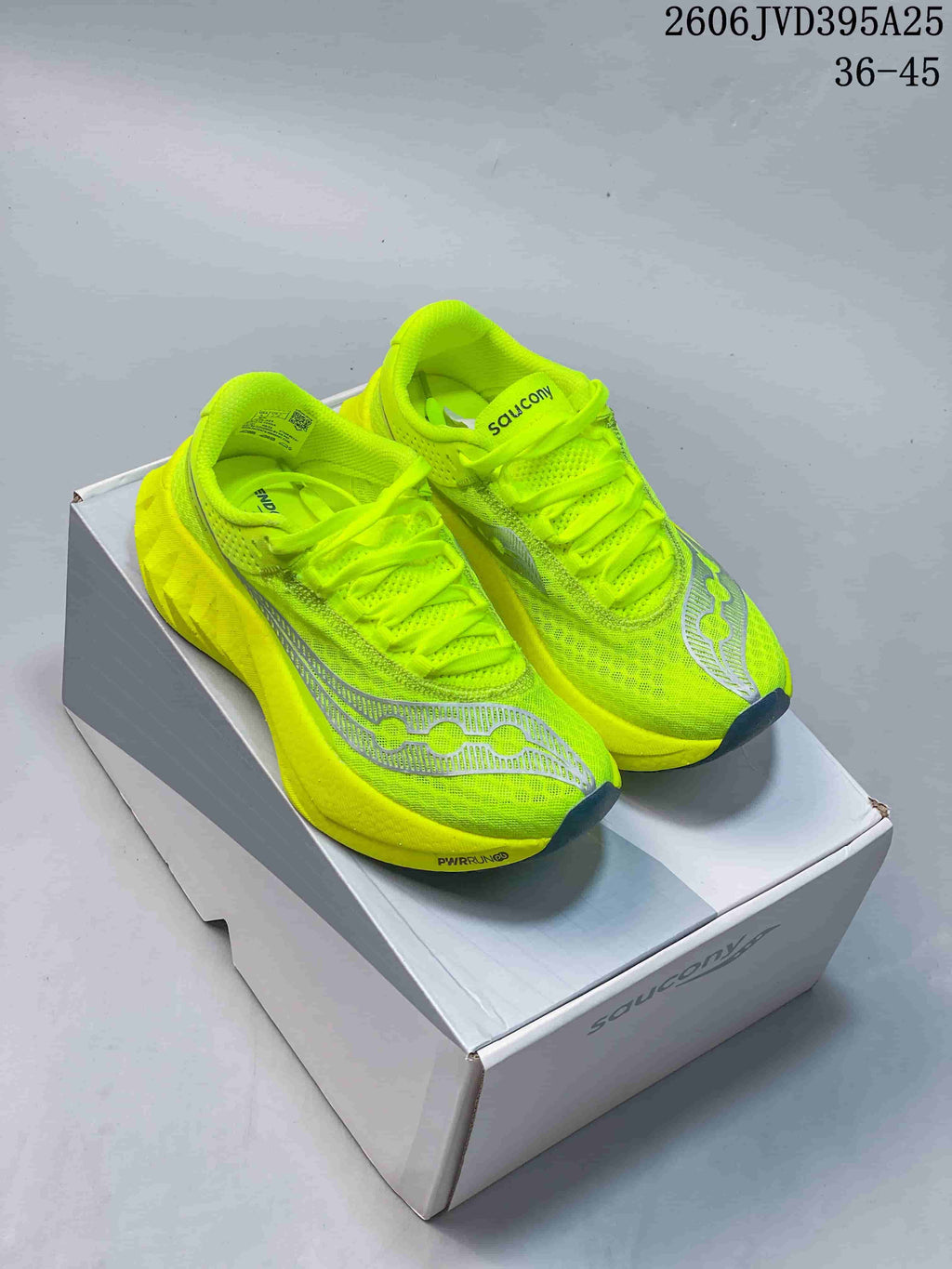 Bright neon yellow Saucony Endorphin Speed 5 running shoes with gray details, displayed on a shoe box.
