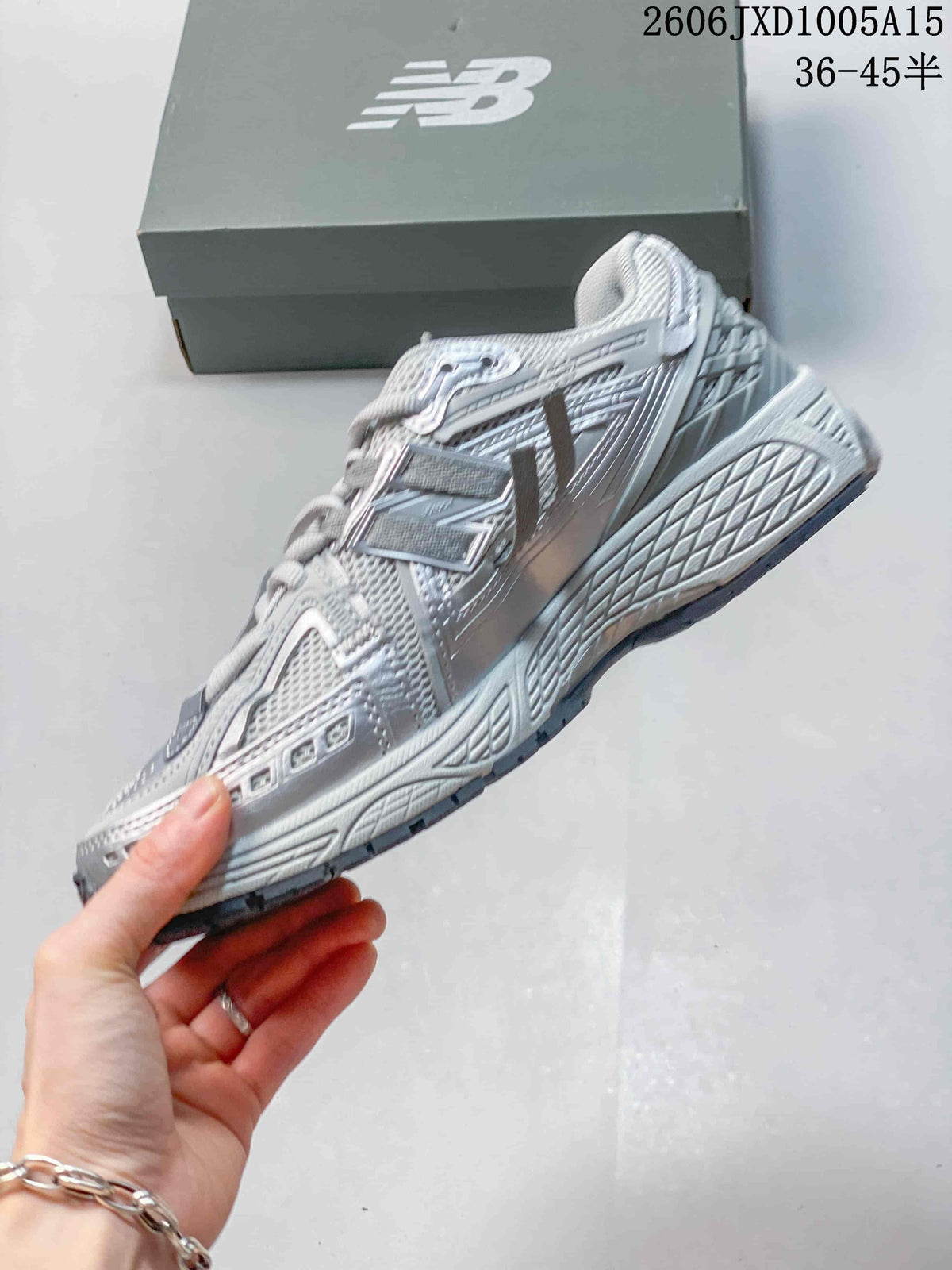 Side view of a silver-grey New Balance 1906 sneaker