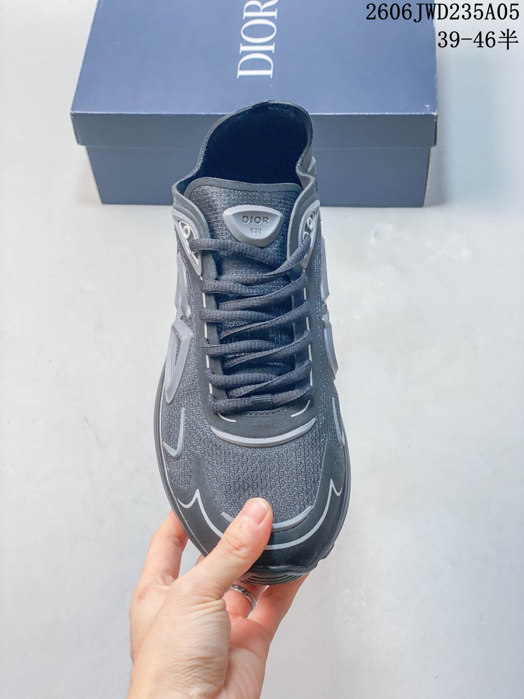 Front view of a grey Dior B30 sneaker showing the laces and textured upper.