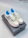 Pair of off-white and light blue Nike Air Force 1 low-top sneakers on a box
