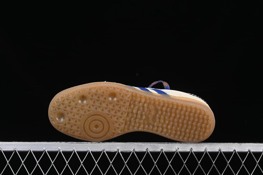 Underside view of the gum-colored outsole with patterned tread.