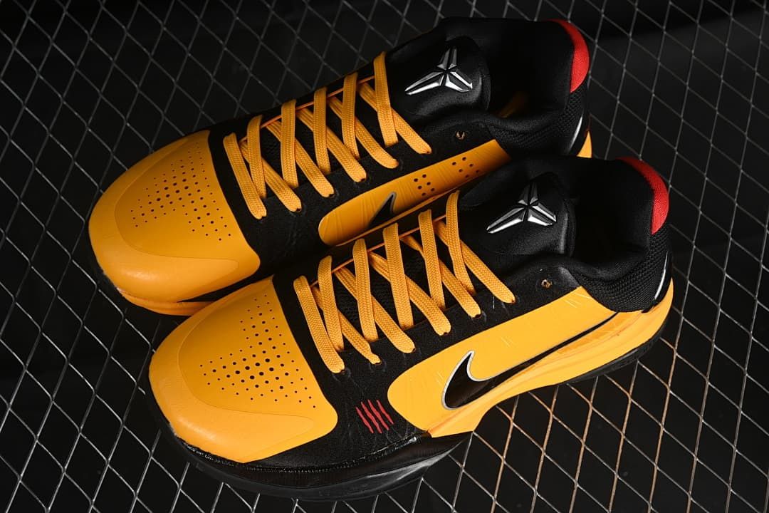 Pair of yellow and black Kobe 5 shoes viewed from above