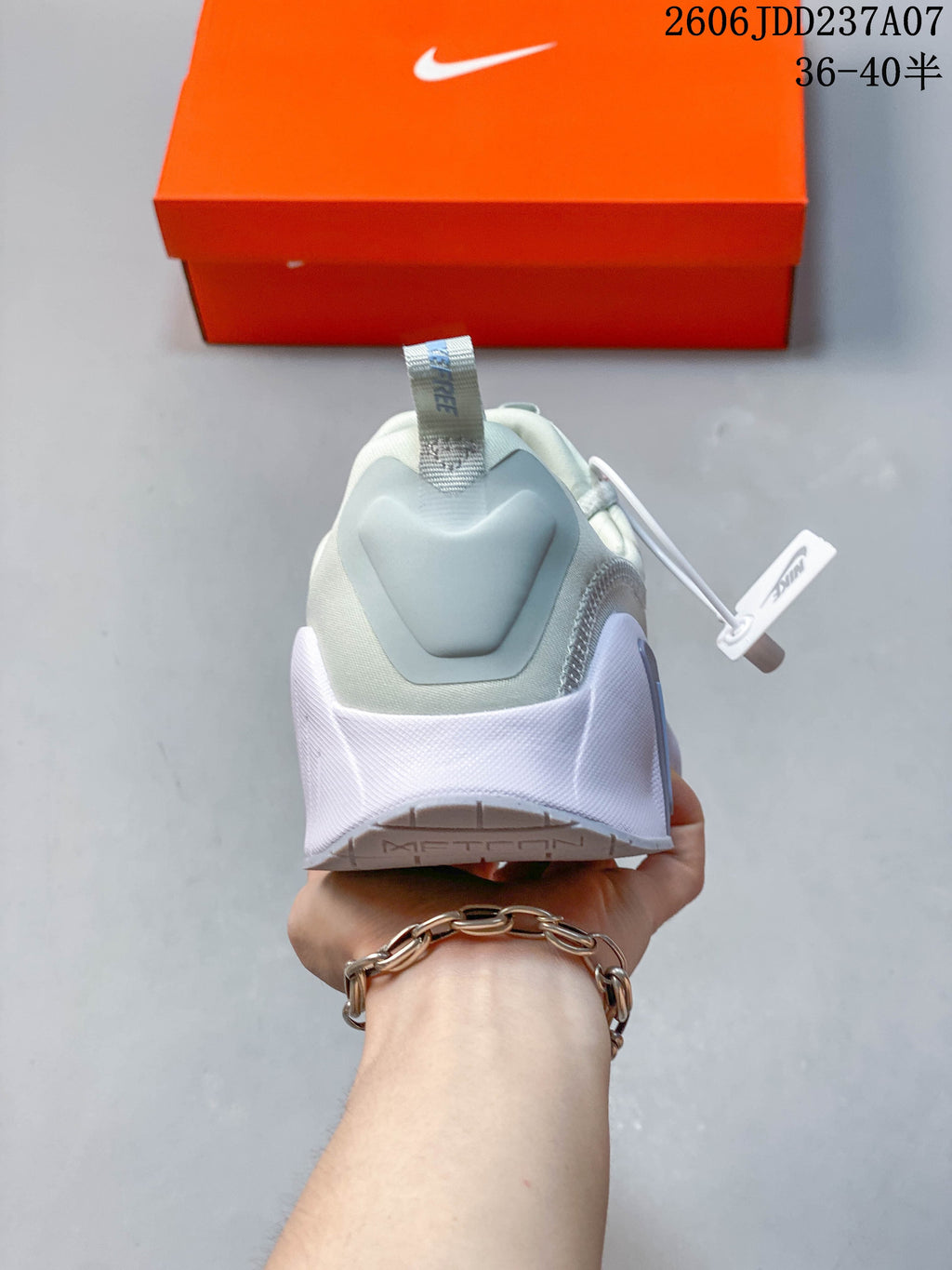 Rear view of a pale mint Nike Free Metcon 6 shoe showing the heel and pull tab