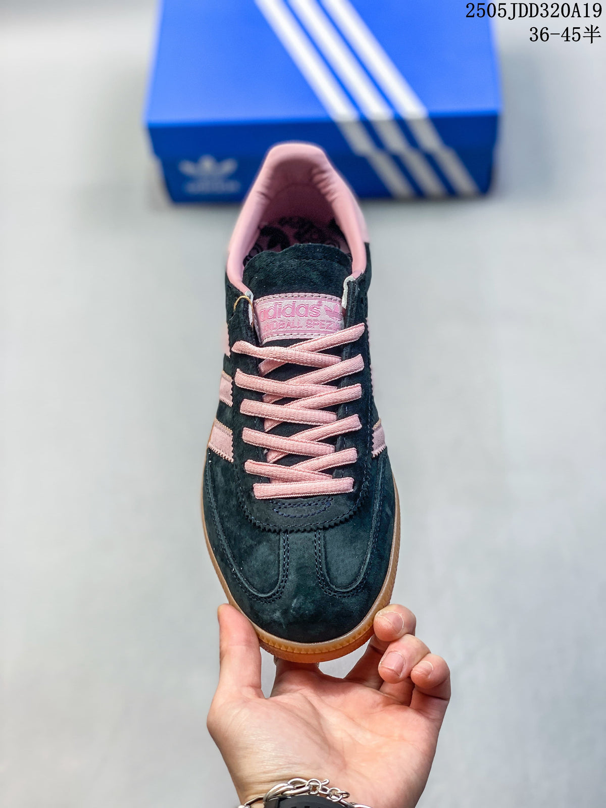 Front view showing the navy upper, pink laces, and pink collar lining