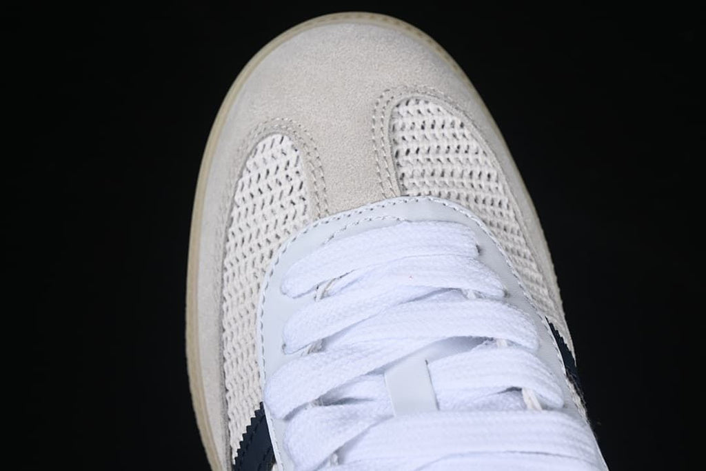 Top view showing the light-colored toe overlay, textured panels, and white laces