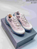 Pair of pale pink and white Kailas FUGA trail shoes with blue and purple outsoles, shown on a shoe box.